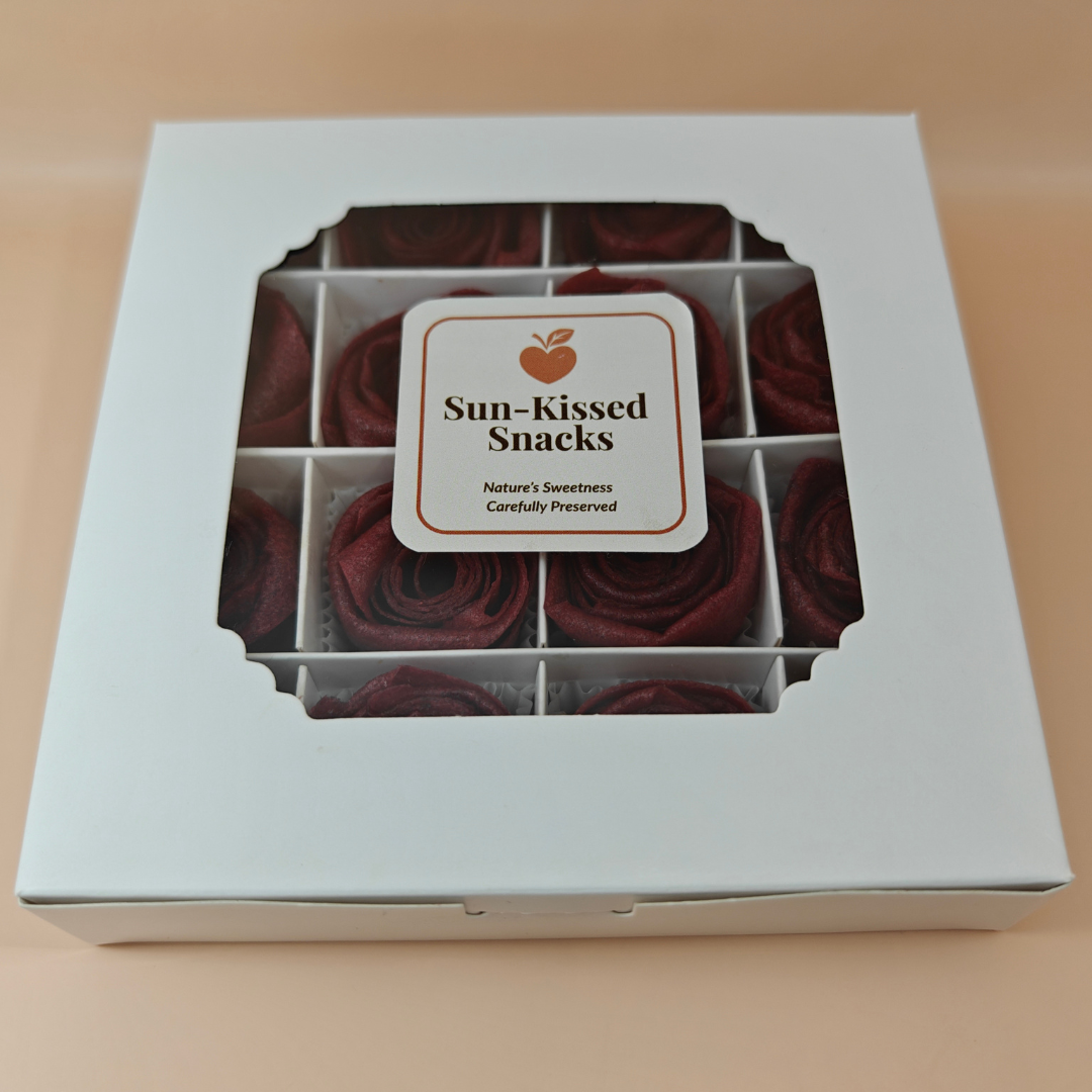 Front of Sun-Kissed Snacks gift box with edible rose pastila visible through window