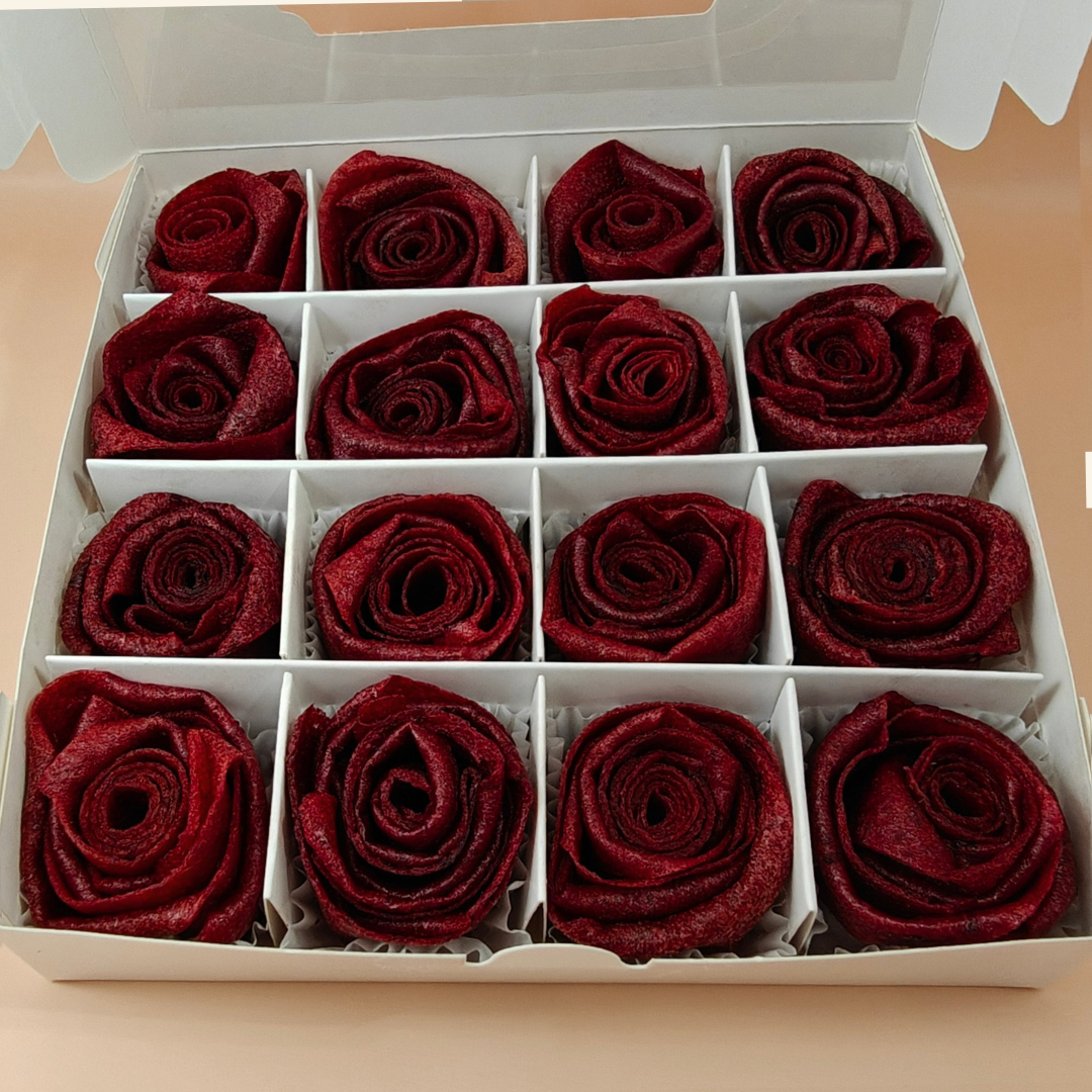 Open box of handcrafted rose-shaped pastila made from dried plum fruit leather