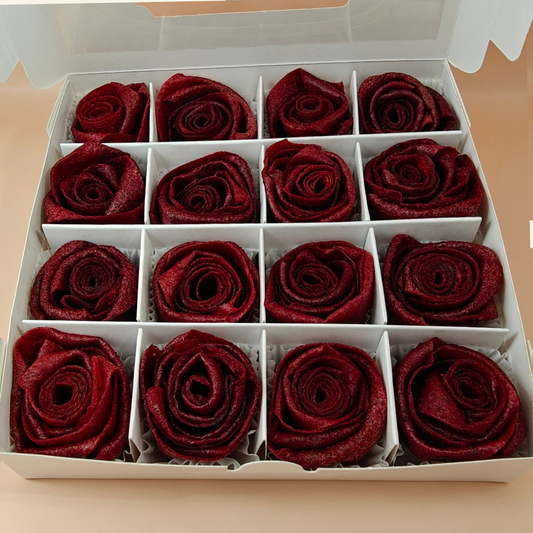 Open box of handcrafted rose-shaped pastila made from dried plum fruit leather