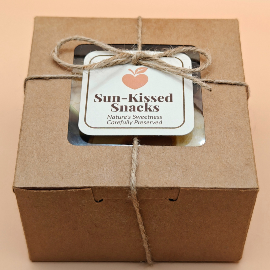 Sun-Kissed Snacks kraft box of dried apple chips with logo tag, shot at a slight angle